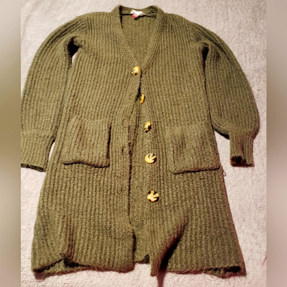 Very Soft,light Sweater.Has buttons going downfront and pockets on the front.